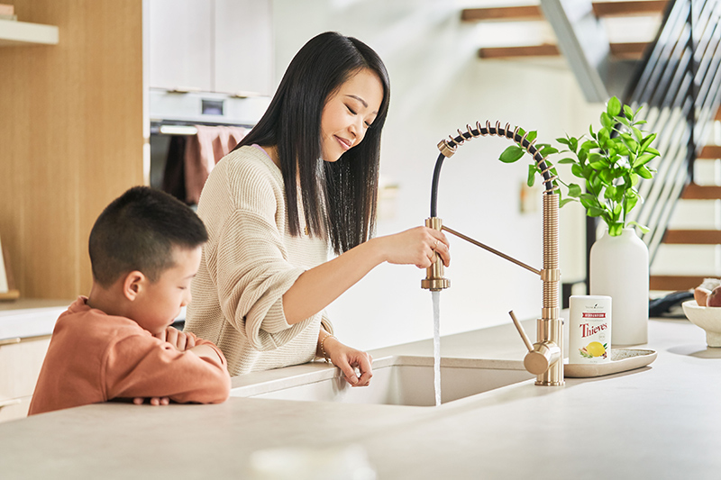 Mum and son washing dishes in kitchen